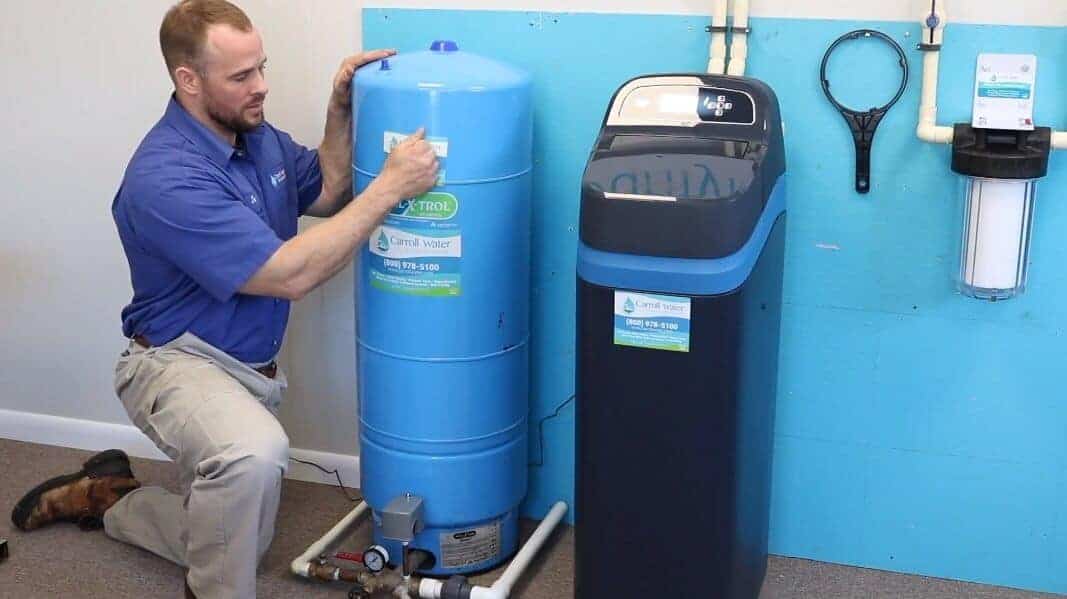 Pictured: A tech replacing a constant pressure tank. First, perform a tap test to check the water level.