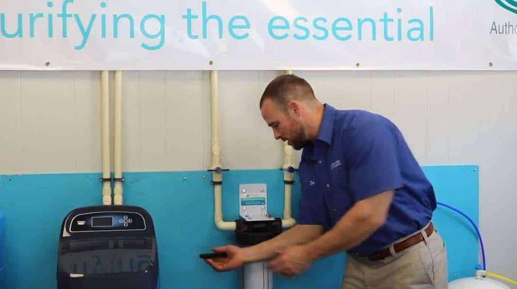 Pictured: Joe Fiorani showing how to change a water filter. Next, loosen and remove the water filter.