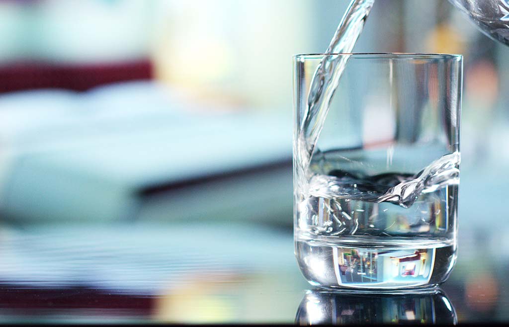 Pure tap water pouring into glass