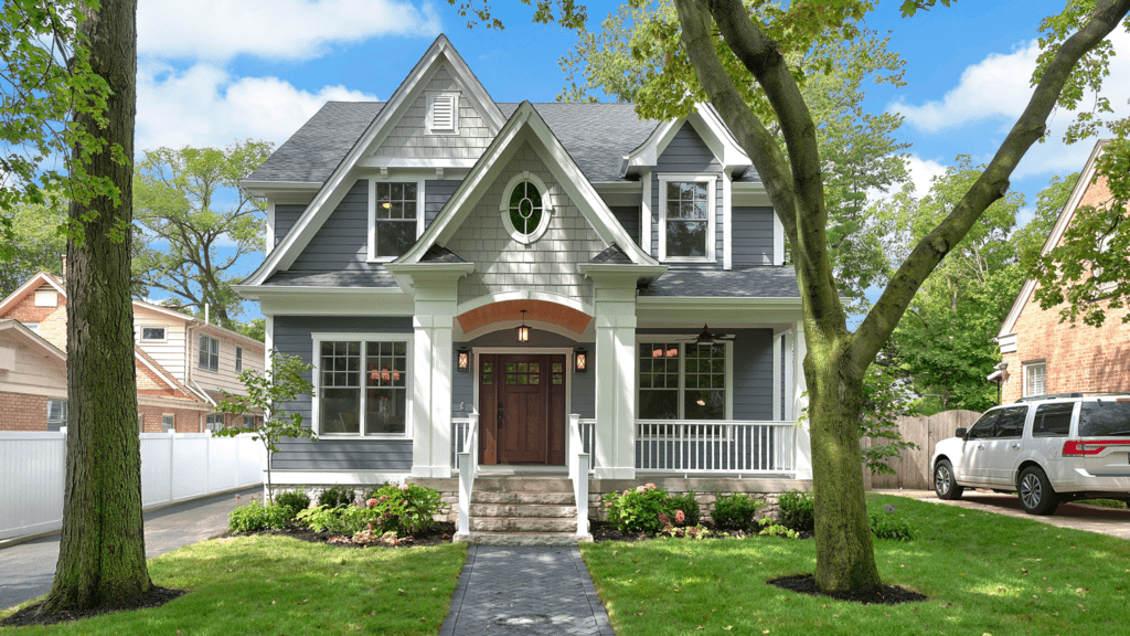 gray two story home with grassy green front yard