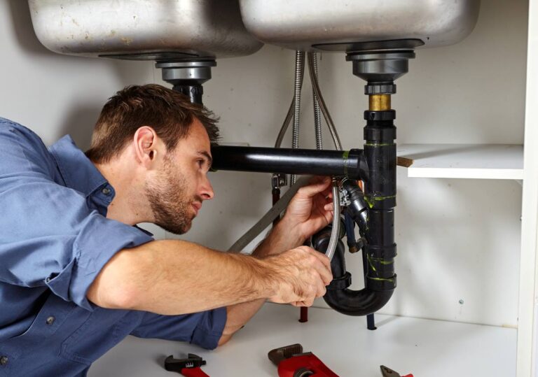 Technician installing an under-the-sink water softener