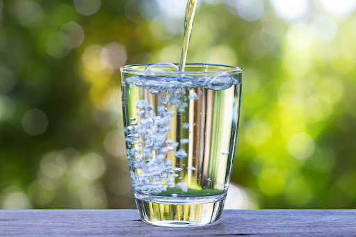 Pure reverse osmosis filtered water being poured into a clear drinking glass.