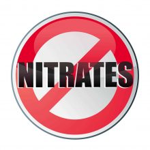A red circle with a slash through it symbol with the word Nitrates in the center